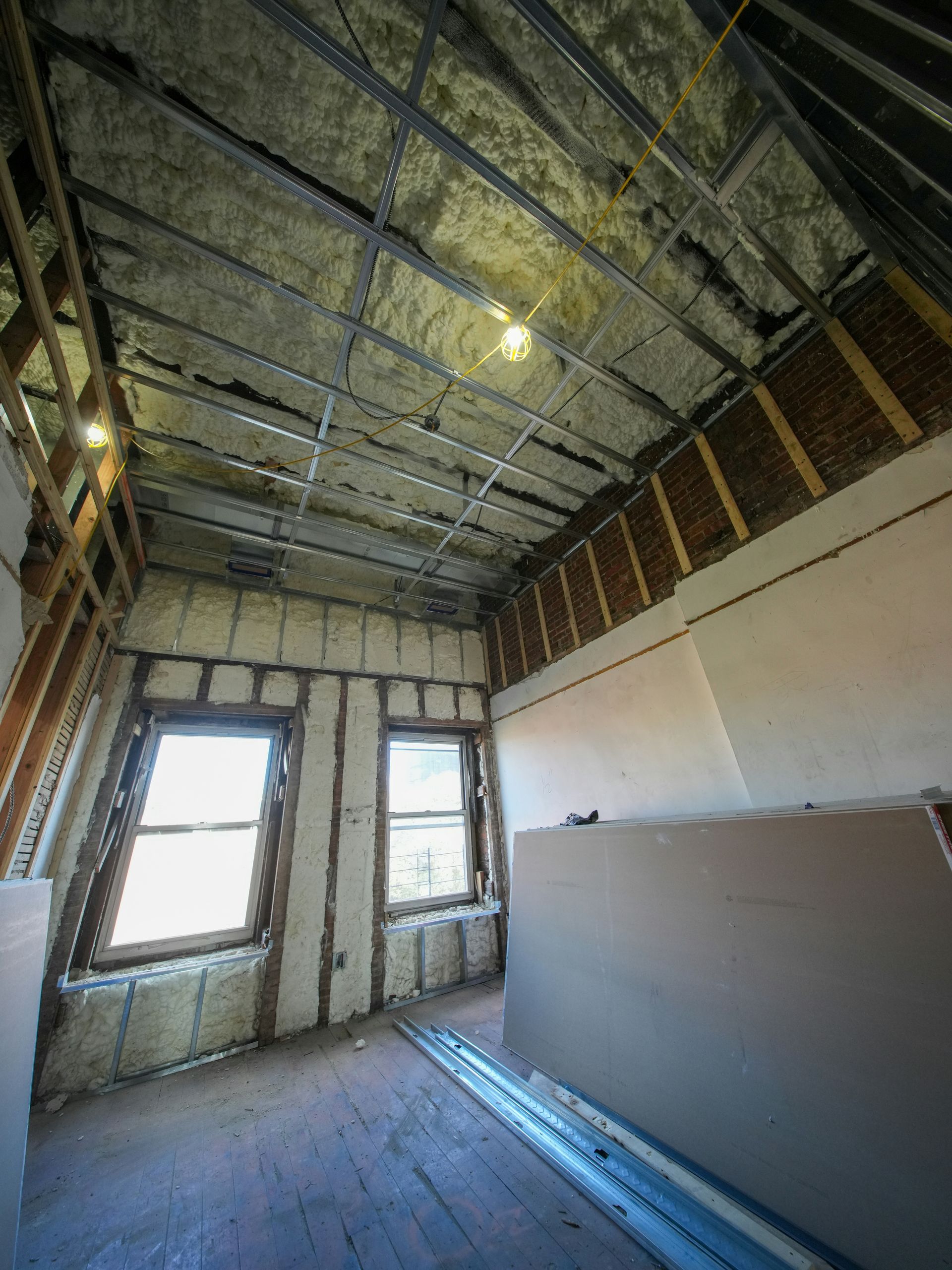 Attic room under construction with exposed framing and insulation