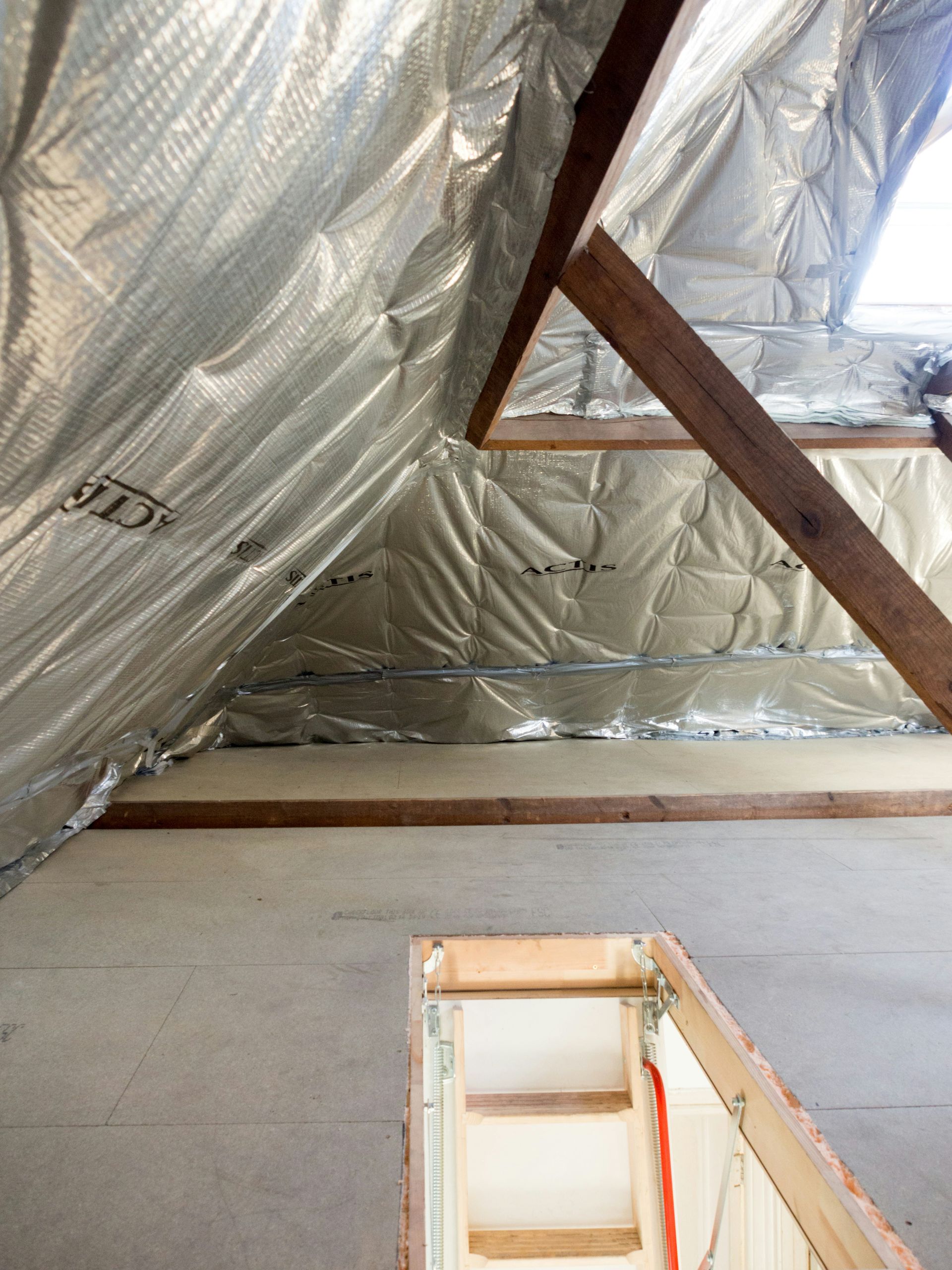 Attic space with insulation and wooden beams